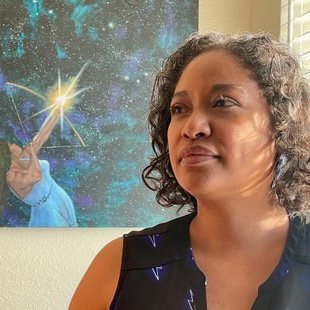 A Diné and Nahiłii (Black) woman looking off camera to the left with a painting of a person shooting an arrow with an illuminated star tip into the starry sky.